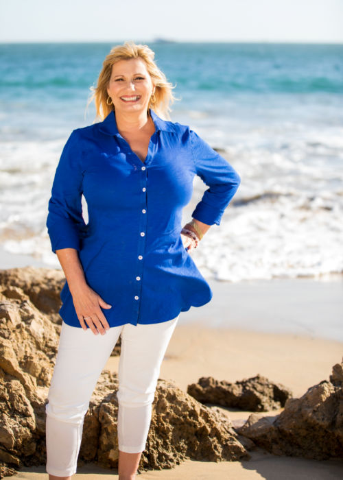 Ruth Lynch standing on a beach.